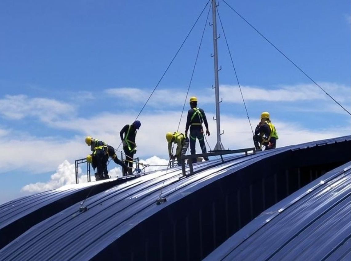 Solar experts installing solar panels on a roof