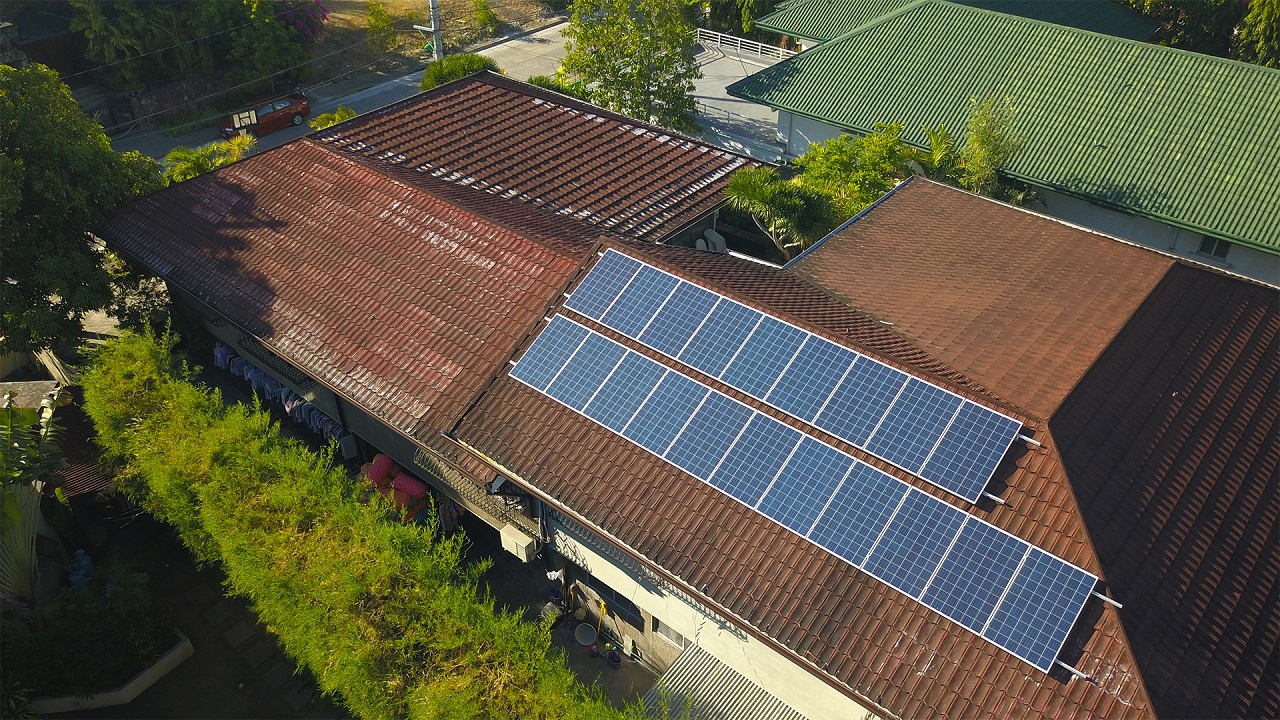 Blue solar panels on top of a home's roof