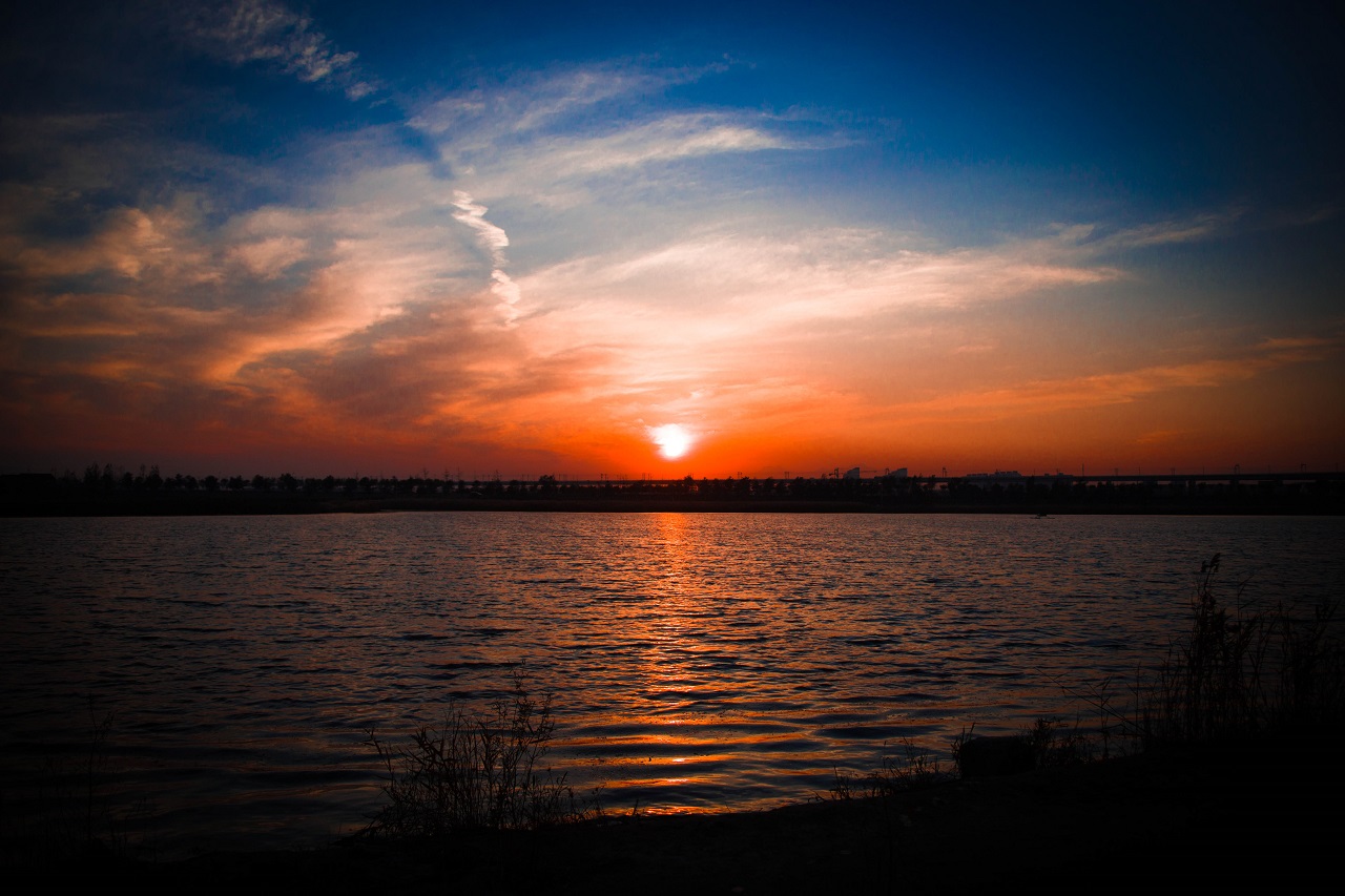 The sun setting on the horizon