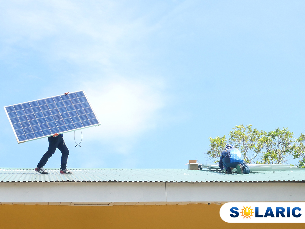 A man installing solar on a rooftop