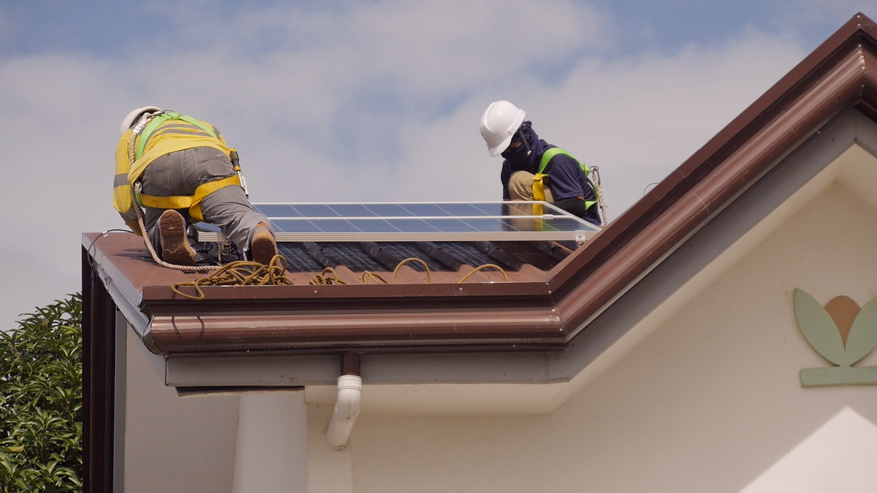 Solaric workers installing a rooftop solar panel