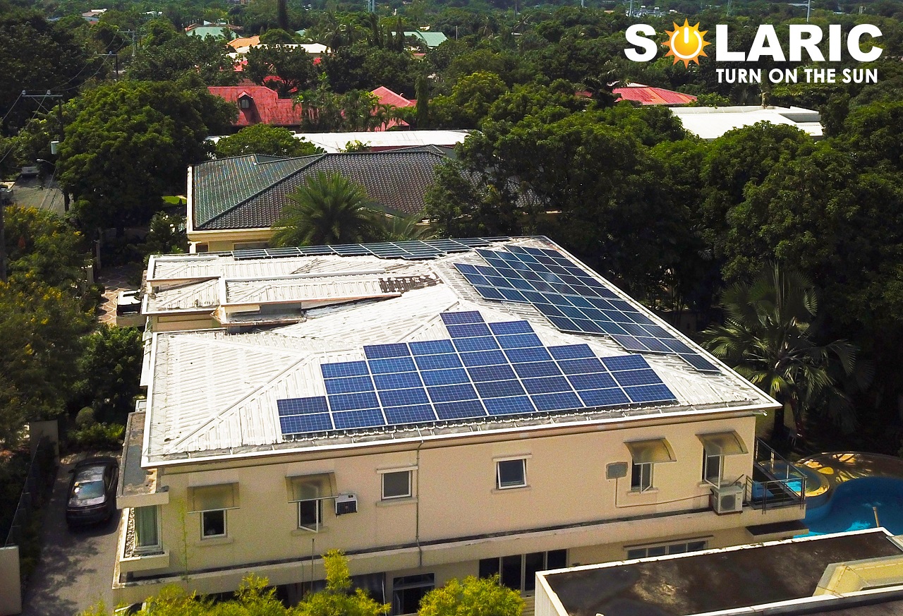 A rooftop with solar panels on one side