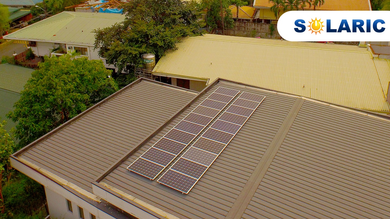 Two rows of solar panels on top of a roof